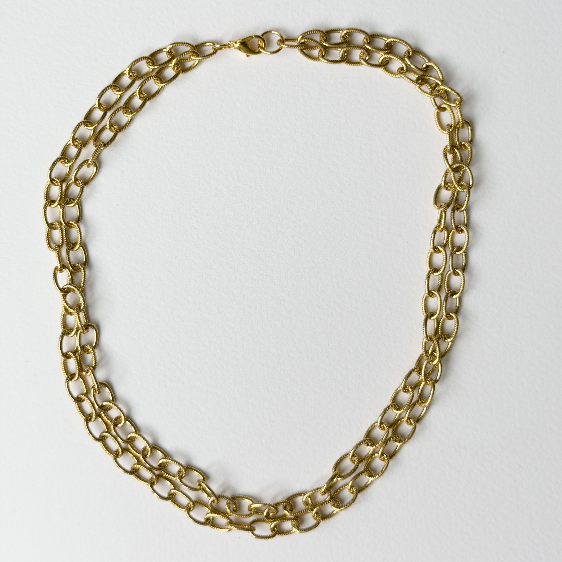 Vera two-strand gold plated chain necklace laid flat